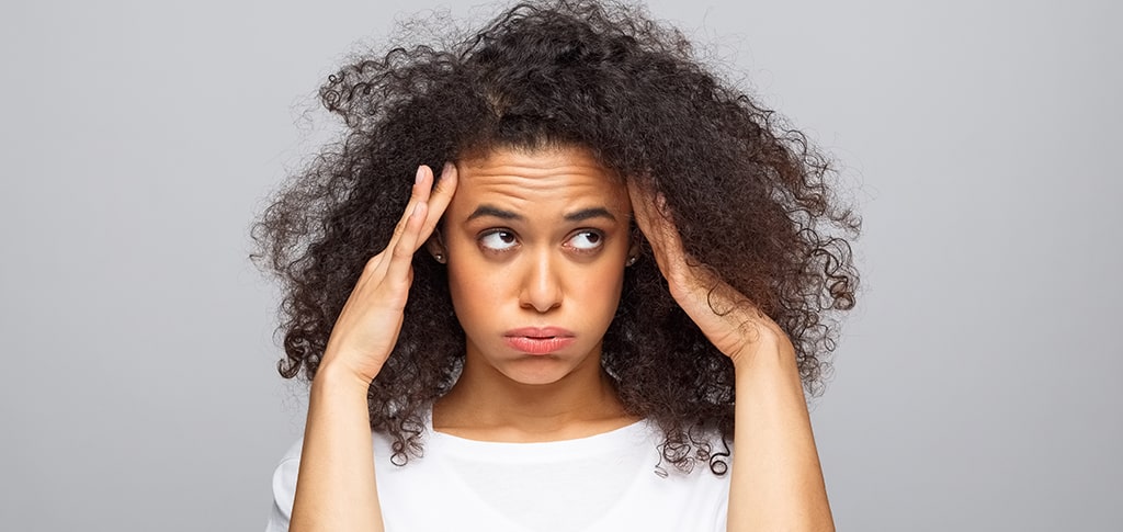Image of Woman Touching Hair With Both Hands