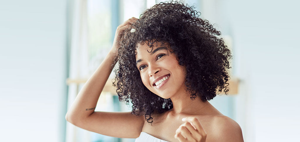 Image of Woman touching her curly natural hair